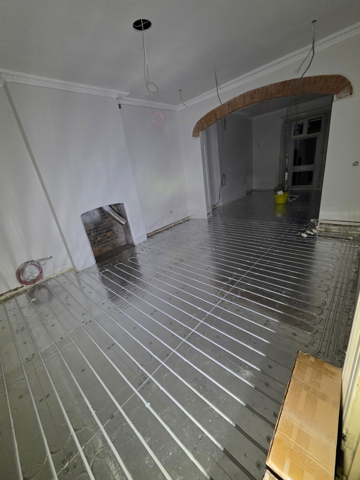 Low-profile foil overlay UFH board laid through a period lounge, ready for floor finish