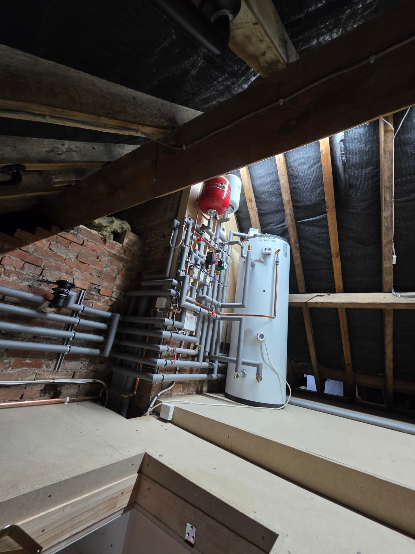 Intergas Xylinder and insulated pipework in a Southam attic plant room