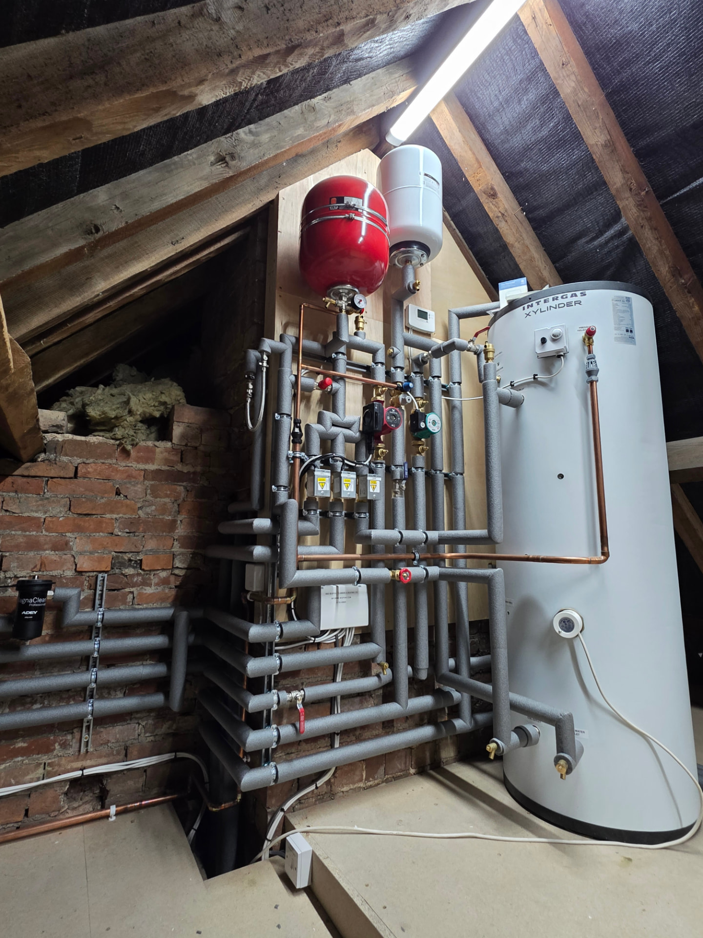 Completed attic unvented cylinder plant room with fully insulated pipework, Southam