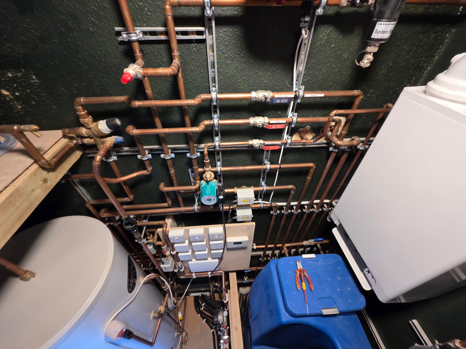 Zoned copper manifold with labelled valves, mid-install