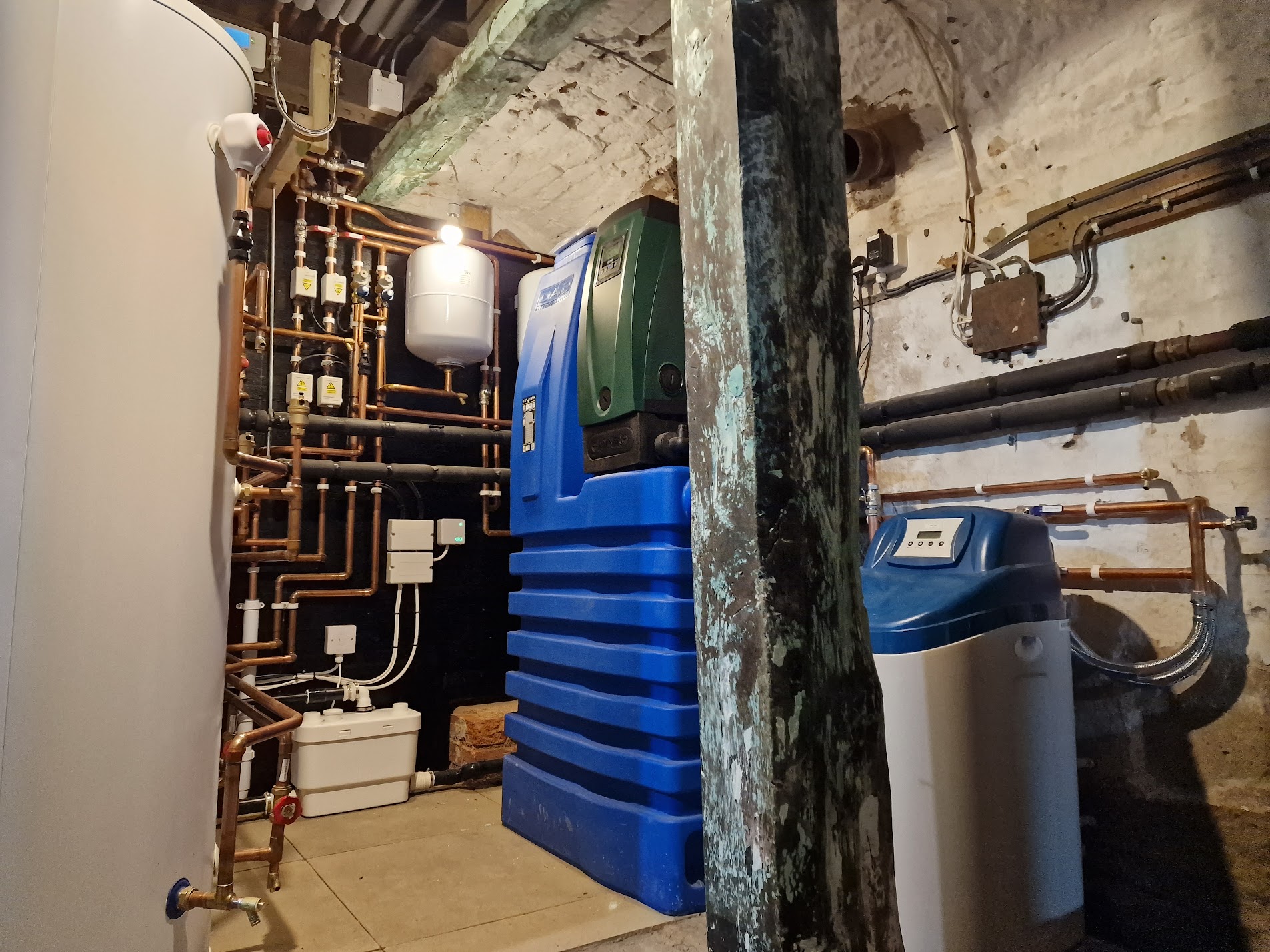 Complete water treatment plant room, softener, mains booster & unvented cylinder in a period cellar