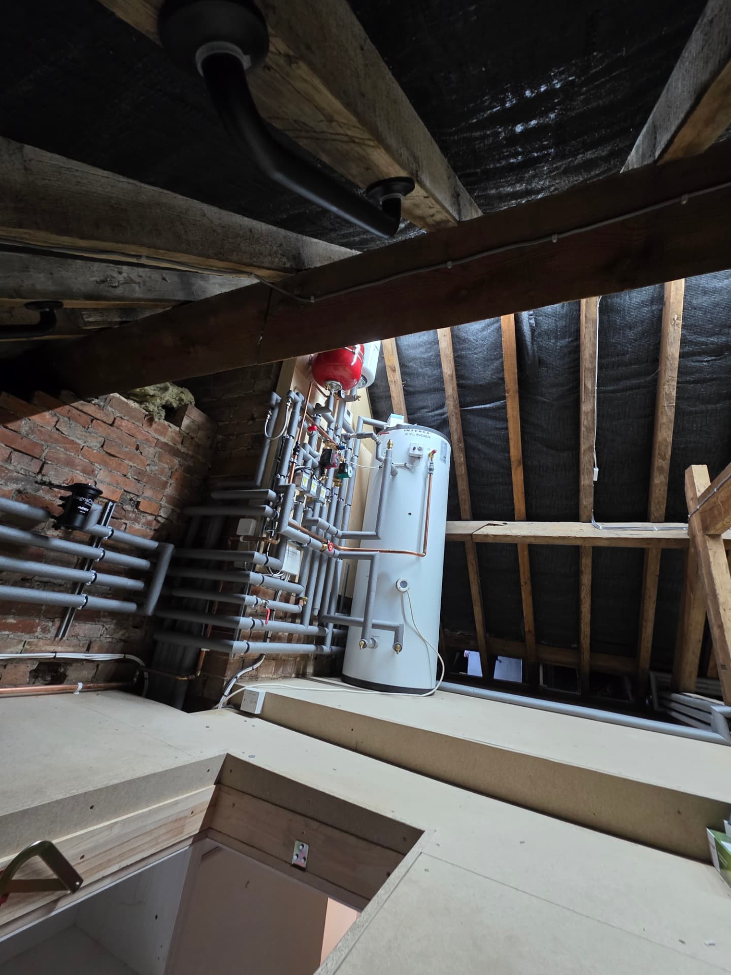 Attic unvented cylinder plant room viewed from the loft hatch, Warwick
