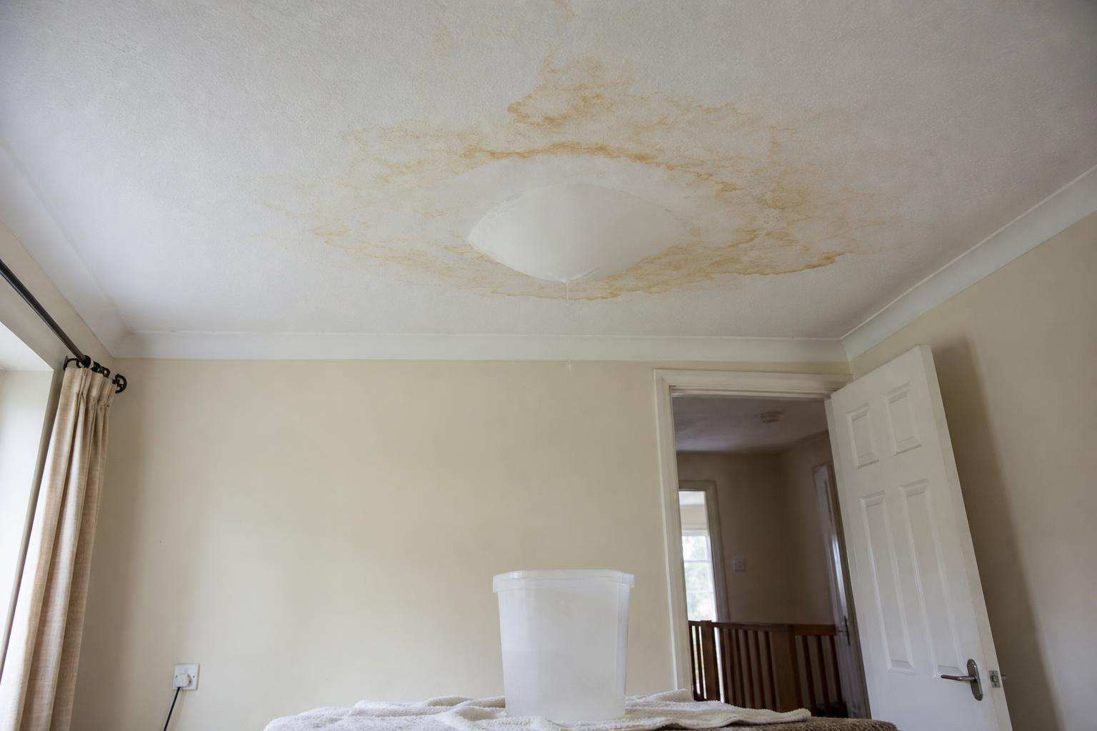 Water staining and a bulging patch on a ceiling below a bathroom leak